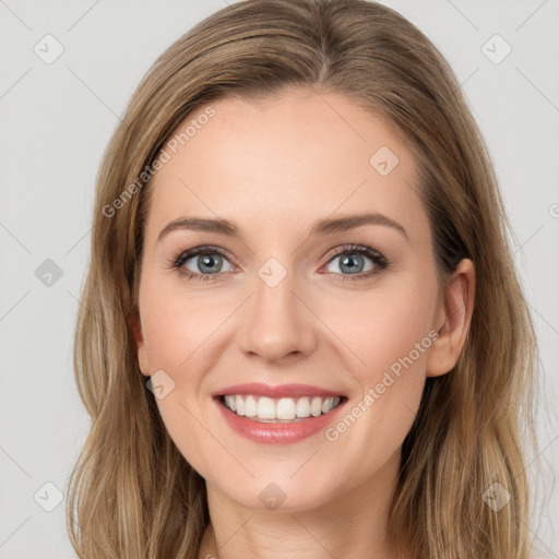 Joyful white young-adult female with long  brown hair and blue eyes