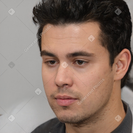 Neutral white young-adult male with short  black hair and brown eyes