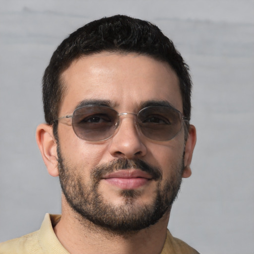 Joyful white young-adult male with short  black hair and brown eyes