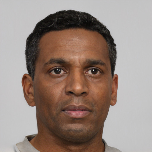 Neutral black adult male with short  black hair and brown eyes