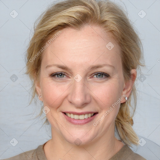 Joyful white adult female with medium  brown hair and blue eyes