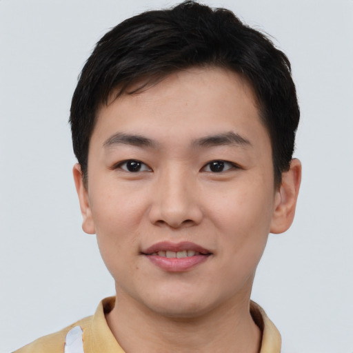Joyful asian young-adult male with short  black hair and brown eyes