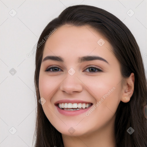 Joyful white young-adult female with long  black hair and brown eyes