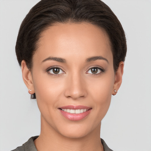 Joyful white young-adult female with short  brown hair and brown eyes