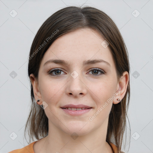 Joyful white young-adult female with medium  brown hair and grey eyes