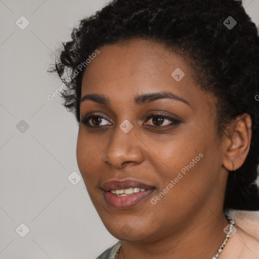 Joyful black young-adult female with short  black hair and brown eyes