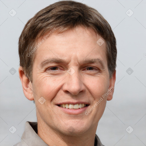 Joyful white adult male with short  brown hair and grey eyes