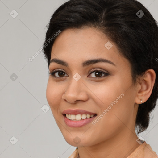 Joyful latino young-adult female with medium  brown hair and brown eyes