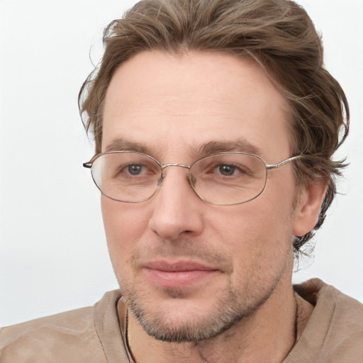 Joyful white adult male with short  brown hair and blue eyes