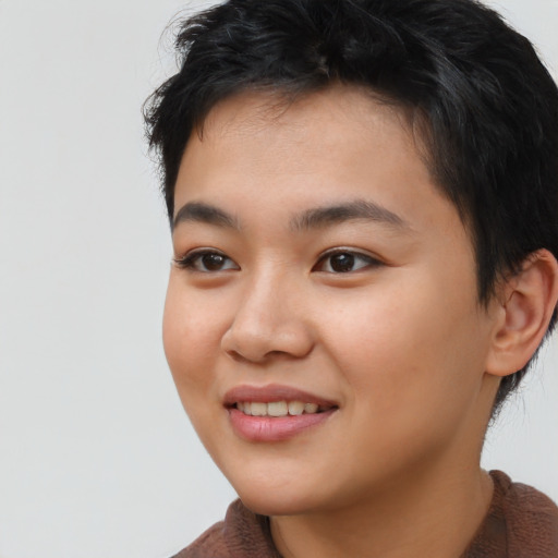 Joyful asian young-adult female with short  brown hair and brown eyes