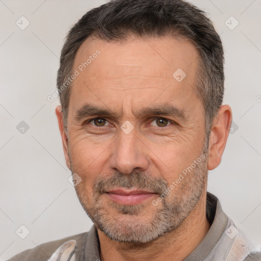 Joyful white adult male with short  brown hair and brown eyes