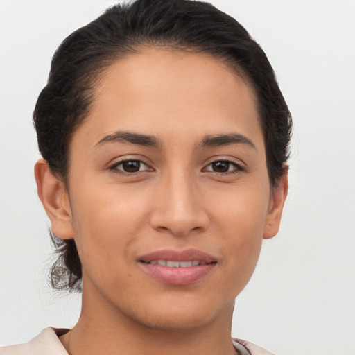 Joyful latino young-adult female with short  brown hair and brown eyes