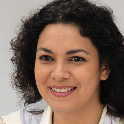 Joyful latino young-adult female with medium  brown hair and brown eyes
