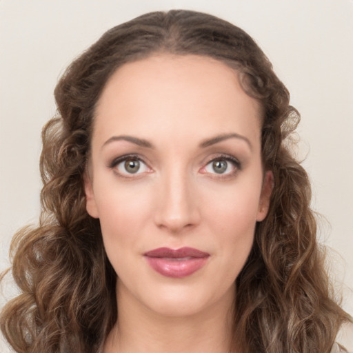 Joyful white young-adult female with long  brown hair and green eyes