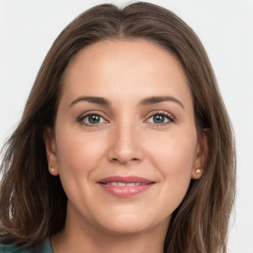 Joyful white young-adult female with long  brown hair and grey eyes