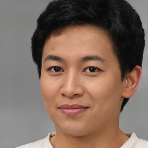 Joyful asian young-adult male with short  brown hair and brown eyes