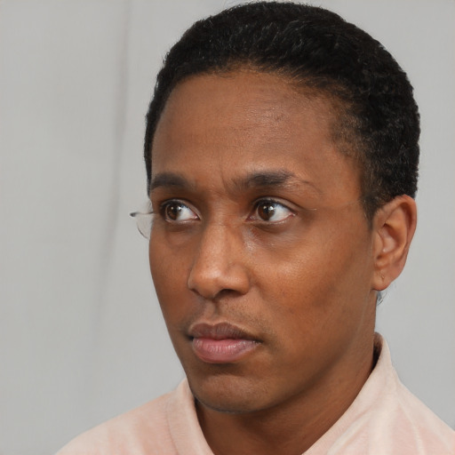 Neutral black adult male with short  black hair and brown eyes