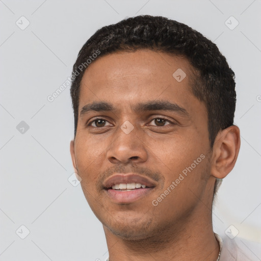 Joyful latino young-adult male with short  black hair and brown eyes