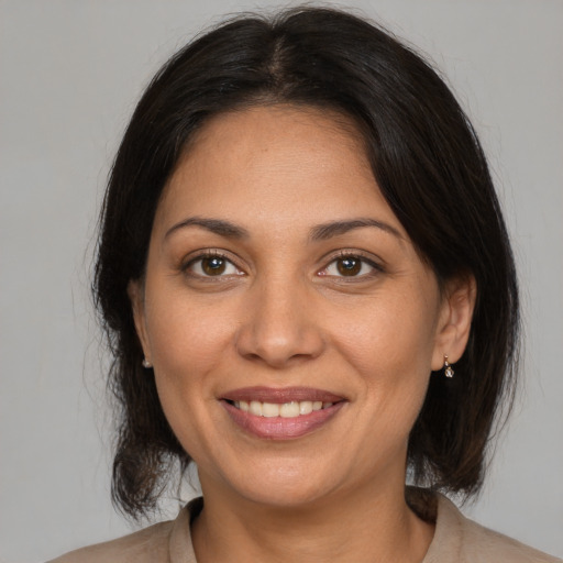 Joyful white adult female with medium  brown hair and brown eyes