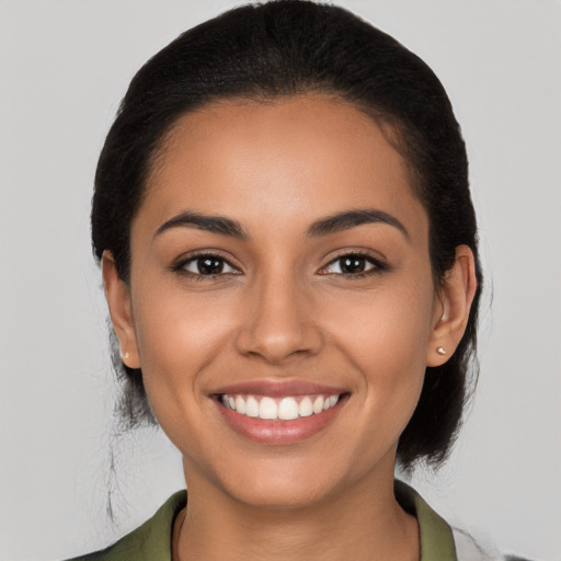 Joyful latino young-adult female with medium  black hair and brown eyes