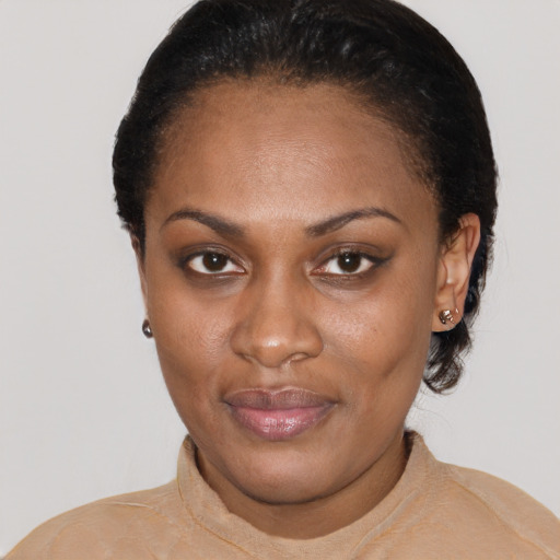Joyful black young-adult female with short  black hair and brown eyes