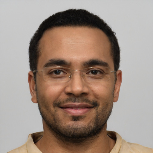 Joyful latino young-adult male with short  black hair and brown eyes