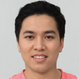 Joyful asian young-adult male with short  black hair and brown eyes