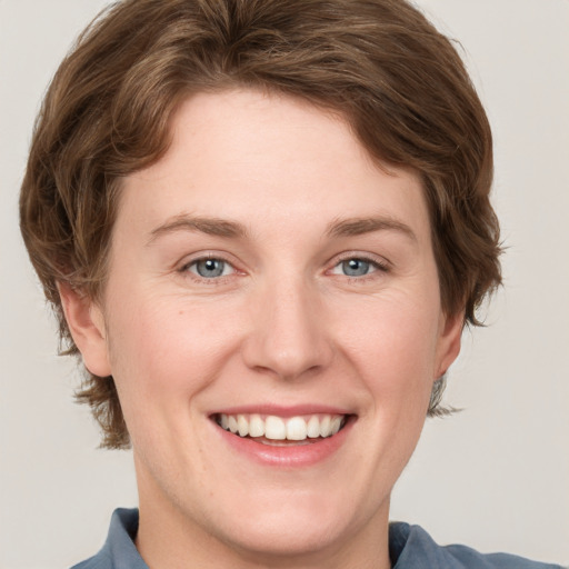 Joyful white young-adult female with medium  brown hair and blue eyes