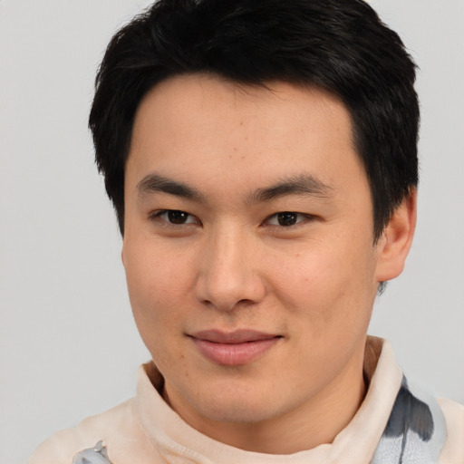Joyful asian young-adult male with short  black hair and brown eyes