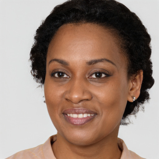 Joyful black adult female with short  brown hair and brown eyes