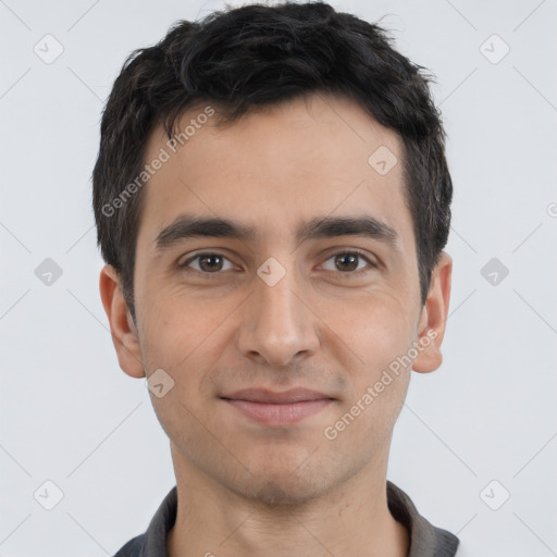 Joyful white young-adult male with short  black hair and brown eyes