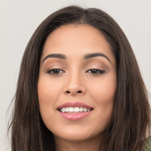 Joyful asian young-adult female with long  brown hair and brown eyes