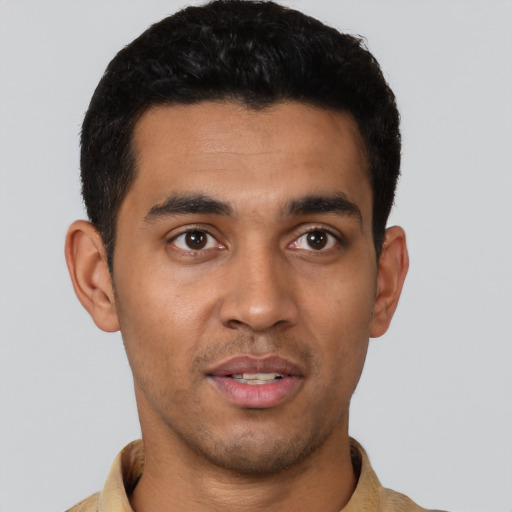 Joyful latino young-adult male with short  black hair and brown eyes