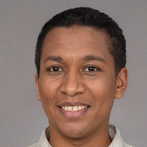 Joyful latino adult male with short  black hair and brown eyes