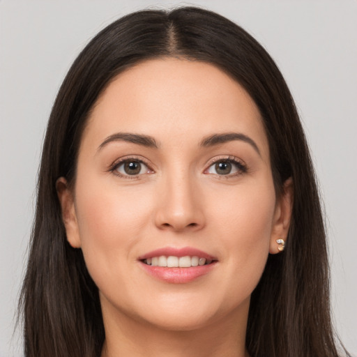 Joyful white young-adult female with long  brown hair and brown eyes