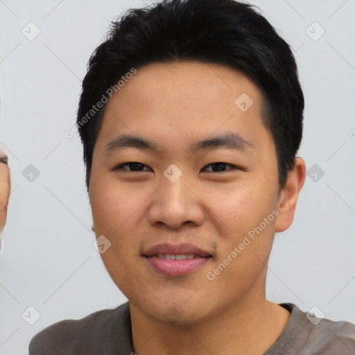 Joyful asian young-adult male with short  black hair and brown eyes