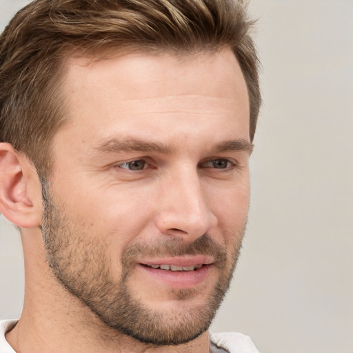 Joyful white young-adult male with short  brown hair and grey eyes