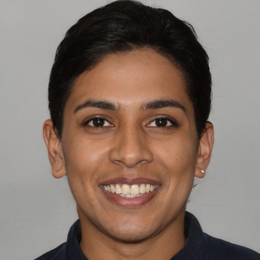 Joyful latino young-adult female with short  black hair and brown eyes