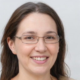 Joyful white adult female with long  brown hair and grey eyes