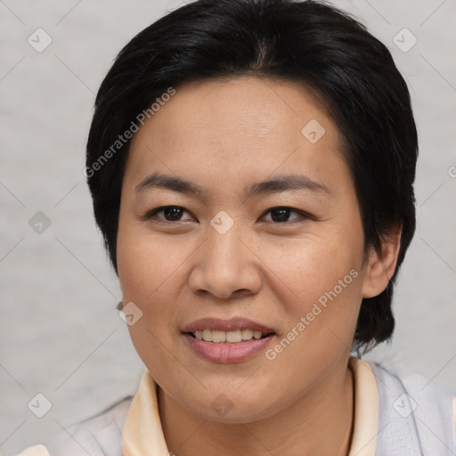 Joyful asian adult female with short  brown hair and brown eyes