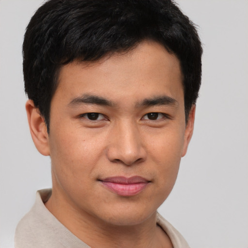 Joyful asian young-adult male with short  brown hair and brown eyes