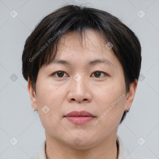 Joyful asian adult female with short  brown hair and brown eyes