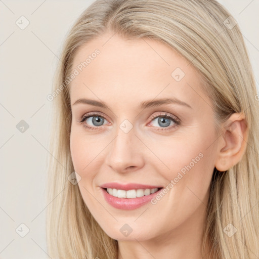 Joyful white young-adult female with long  brown hair and blue eyes