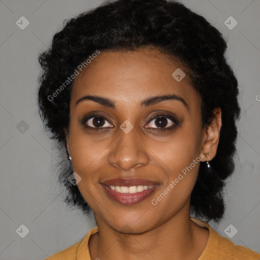 Joyful black young-adult female with long  black hair and brown eyes