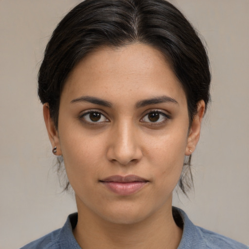 Joyful latino young-adult female with medium  brown hair and brown eyes