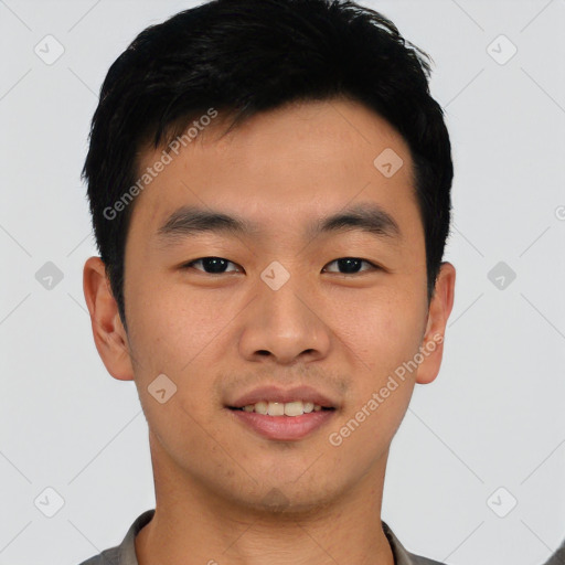 Joyful asian young-adult male with short  black hair and brown eyes