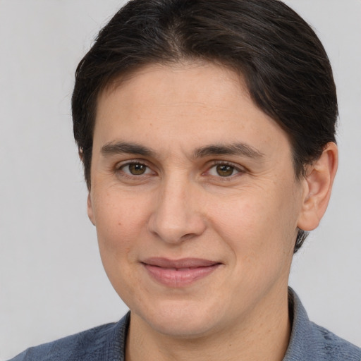 Joyful white adult female with medium  brown hair and brown eyes