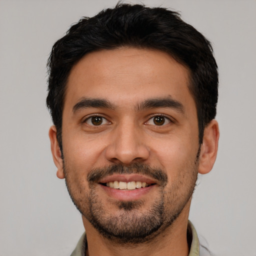 Joyful white young-adult male with short  black hair and brown eyes