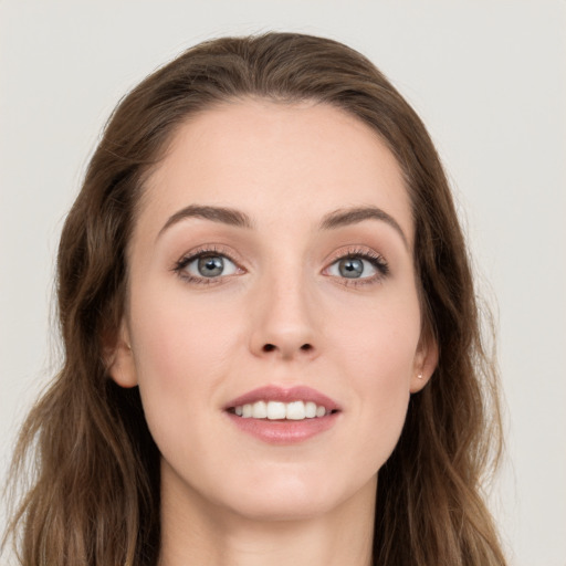 Joyful white young-adult female with long  brown hair and grey eyes