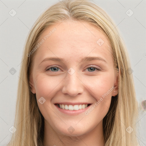 Joyful white young-adult female with long  brown hair and blue eyes